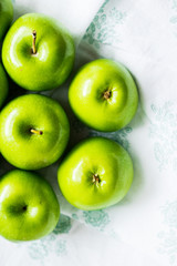Bright green apples on white napkin