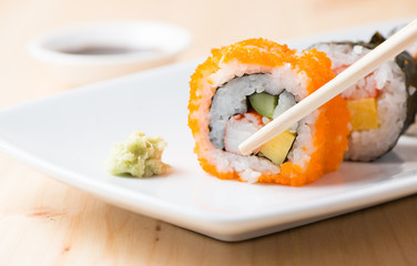 tobiko sushi on chopstick.