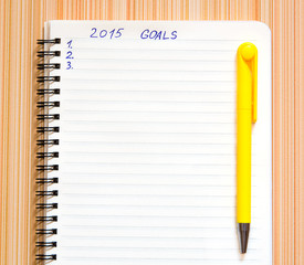 Notebook with yellow pen and goals of year 2015