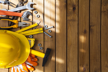 Carpenter tools on wooden background
