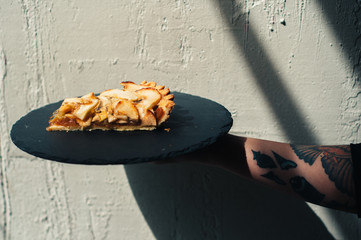 homemade delicious traditional apple pie with caramel on a plate concrete diy plate cool girl with...