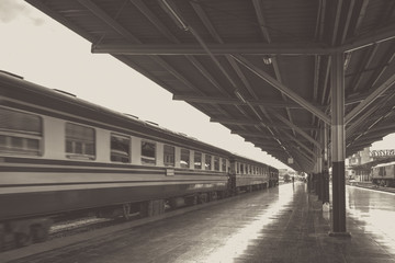 Perspective of train, Diesel locomotive while it moving, on Bangkok railway station platform Thailand, black and white, vintage effect