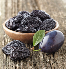 Prune on a wooden background