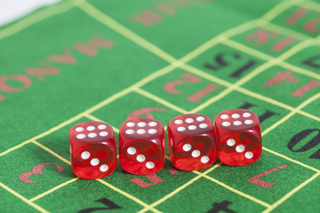roll of the red dice on a game table in a casino