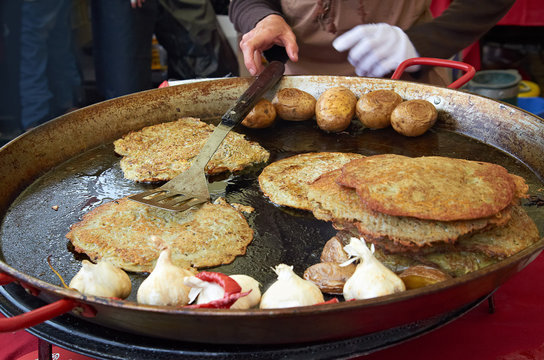 cooking potato pancakes in the street of Cesky Krumlov