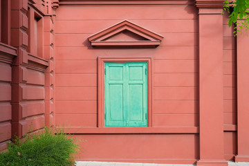 Green Windows on Red Wall