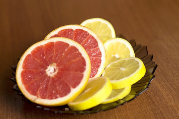 sliced grapefruit and lemon lying on the plate