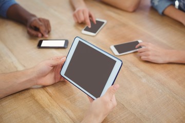 High angle view of cropped hand holding digital tablet 