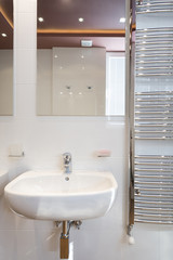 Fototapeta na wymiar Modern bathroom interior with heated towel rail