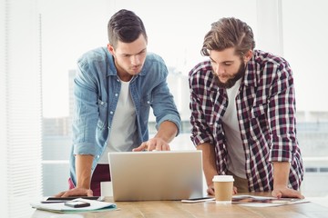 Businessmen working on laptop 