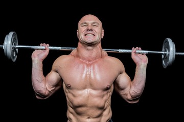 Fototapeta na wymiar Confident muscular man lifting crossfit
