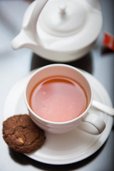 cup of black tea with cookie