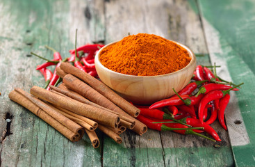 Cinnamon sticks  chili and  turmeric on wooden