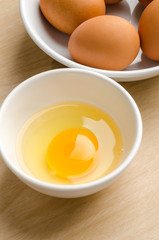 Fresh egg yolk in the bowl on wooden background,food ingredient