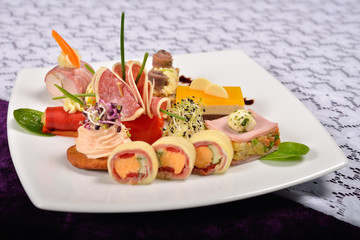 Antipasto and catering platter with different appetizers(fruits,