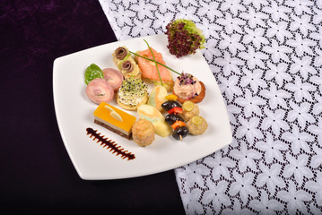 Antipasto and catering platter with different appetizers(fruits,