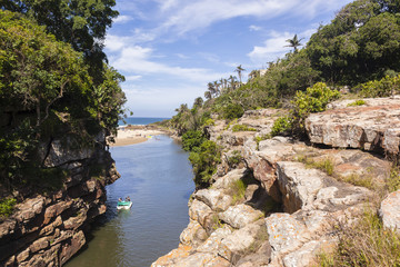 River lagoon rocky cliffs paddle boats beach ocean holiday landscape