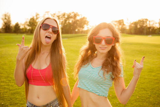 two sexy funny girls with red glasses fooling around