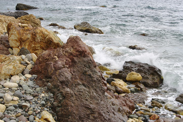 Colorful stones and pebbles closeup on seashore, Iashmovyi (Jasper) beach of Cape Fiolent, Crimea