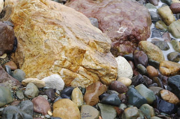Colorful stones and pebbles on seashore closeup