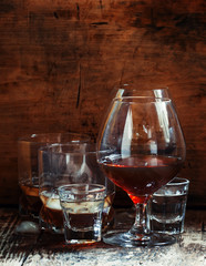 Set of hard liquor brandy, whiskey, brandy and vodka on the old