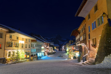 Fototapeta na wymiar Picturesque winter night view of the medieval town of Gruyeres
