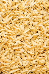 Background of fresh homemade egg tagliatelle