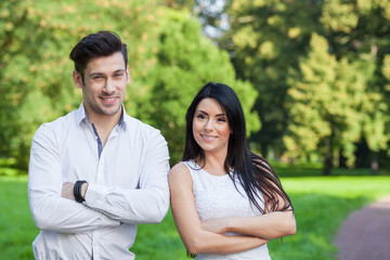 Fototapeta premium young couple looking to camera in park