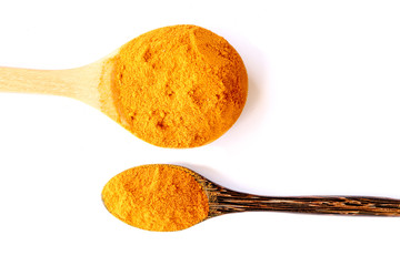 Organic turmeric (curcuma) powder with spoon isolated on white background