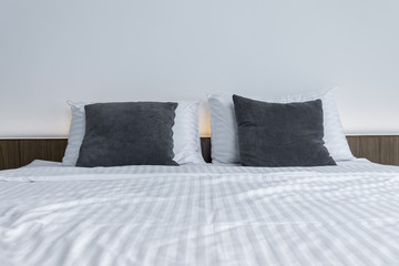 white bedding and pillow on bed Comfortable soft pillow on the b
