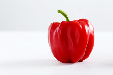 Red pepper on white wooden background