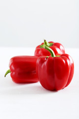Red pepper on white wooden background