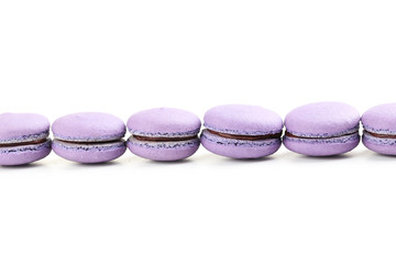 Tasty purple macarons on white background