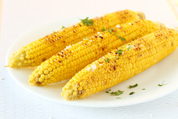 Fresh tasty grilled corn on white plate