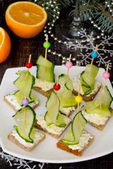 Deurstickers Appetizer canape sandwich with a cucumber on a wooden table © elena_hramowa