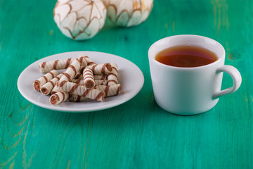 Tubules wafer and tea with a on an old table
