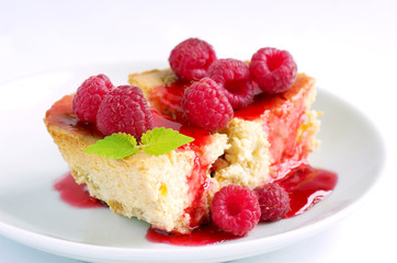 cake with raspberries and cream cheese decorated with fresh rasp