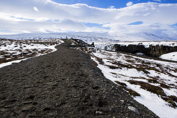 Tourists at the Icelandic waterfall Godafoss in wintertime