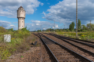 Fototapeta na wymiar Abandoned water tower near old railway track