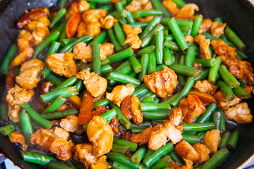Stir fry chicken, sweet peppers and green beans. Top view