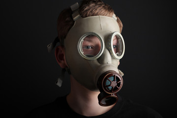 Man with gas mask on black  background