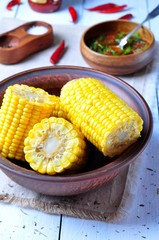 boiled corn with hot tomato sauce, herbs, salt and spices