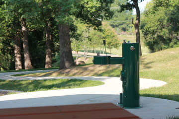Green water fountain at a park