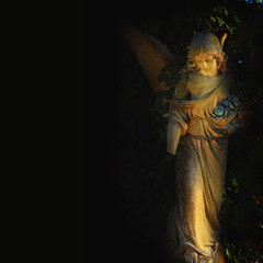 golden angel in the sunlight on black background