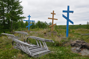 Traditional nenets graves with orthodox crosses, deer's bells, and sleds for afterlife (Yamal...