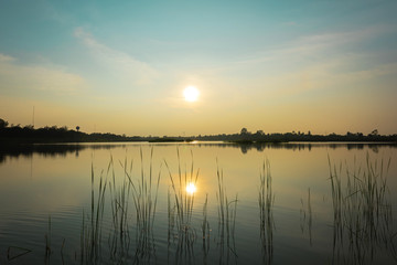 Fototapeta na wymiar Sunset landscape at the calm lake