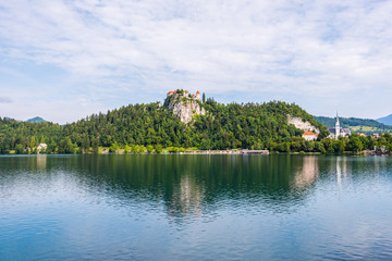 Fototapeta na wymiar Bled Castle at Bled Lake in Slovenia Reflected on Water