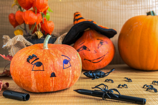 Halloween decoration. Close up of painting a pumpkin.