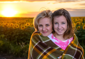 Fototapeta premium Mother and Daughter on Country Road at Sunset