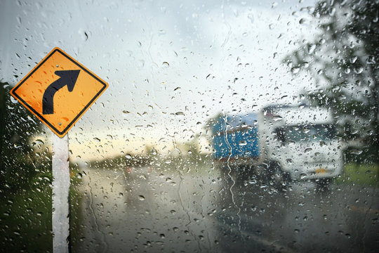 View through the wind shield of rainy day with bike lane sign,Shallow depth of field composition.